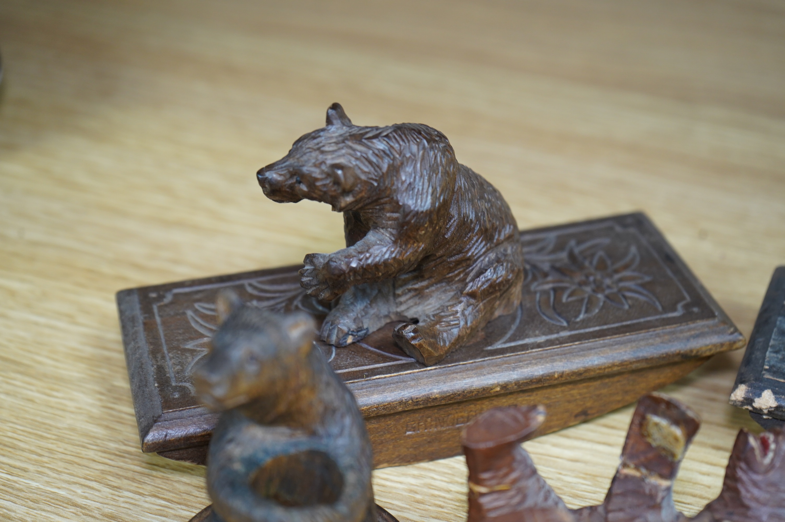 Five carved Black Forest bears, two in the form of ink blotters, together with an African figure of a hippopotamus, largest 17cm wide. Condition - poor to fair